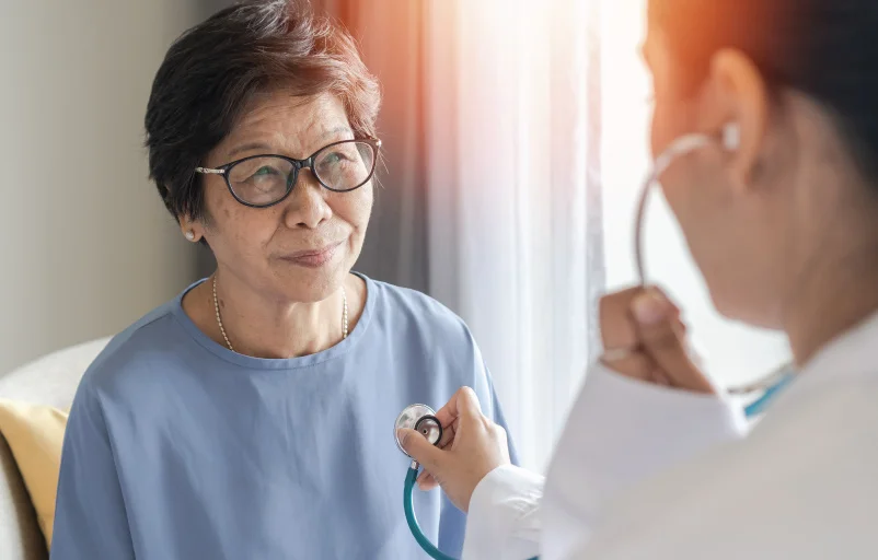 adult asian woman at cardiologist office receiving health checkup