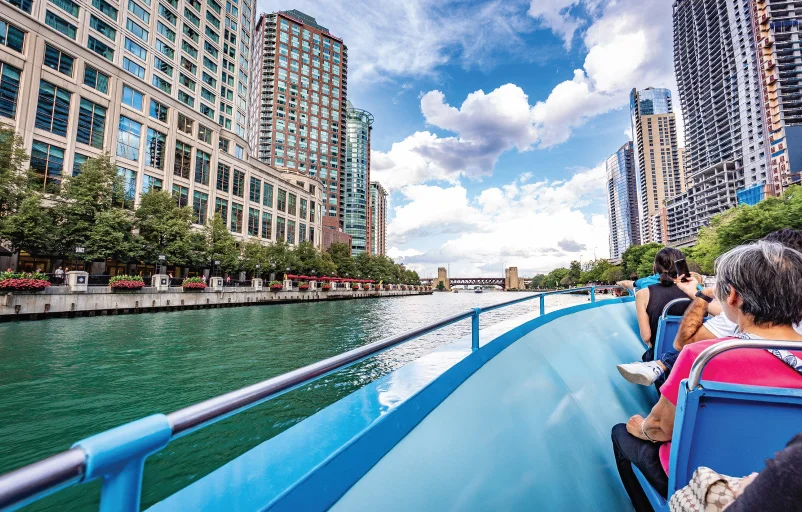 group of adults sightseeing Chicago from a riverboat tour